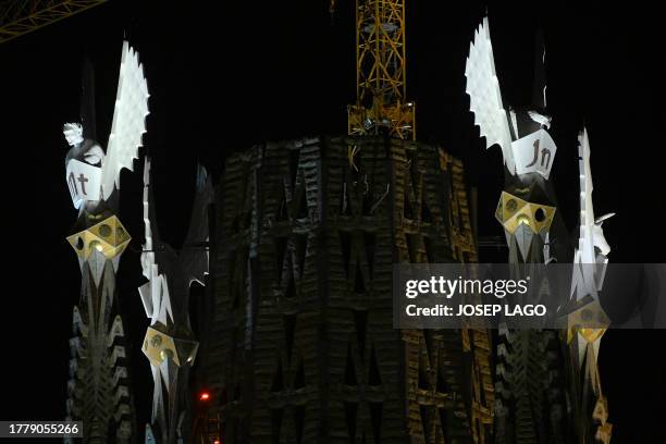 The pinnacles of the Sagrada Familia basilica's four towers of the Evangelists Matthew , Mark , John and Luke are lit up for the first time,...