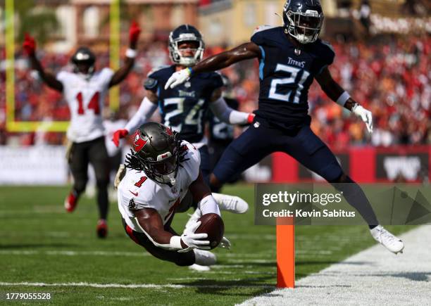 Rachaad White of the Tampa Bay Buccaneers dives into the end zone to score a touchdown during the second quarter of an NFL football game against the...