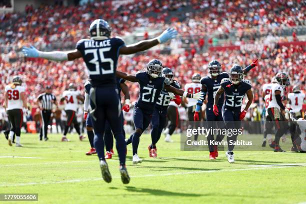 Roger McCreary of the Tennessee Titans celebrates with teammates after intercepting a pass during the first quarter of an NFL football game against...