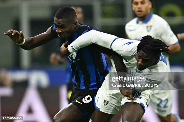 Inter Milan's French forward Marcus Thuram fights for the ball with Frosinone's Italian defender Caleb Okoli during the Italian Serie A football...