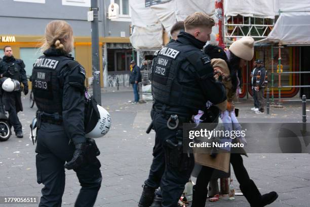 Police are arresting a pro-Palestinian protester while nearly a thousand pro-Palestinian protesters are gathering on the opposite side of Dom...