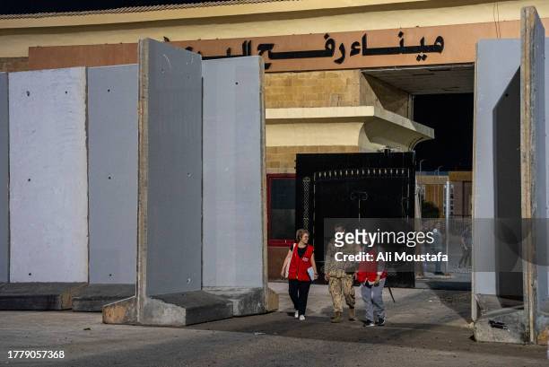 Representatives of the Canadian government walk near the newly re-opened border crossing between Egypt and the Gaza Strip on November 12, 2023 in...