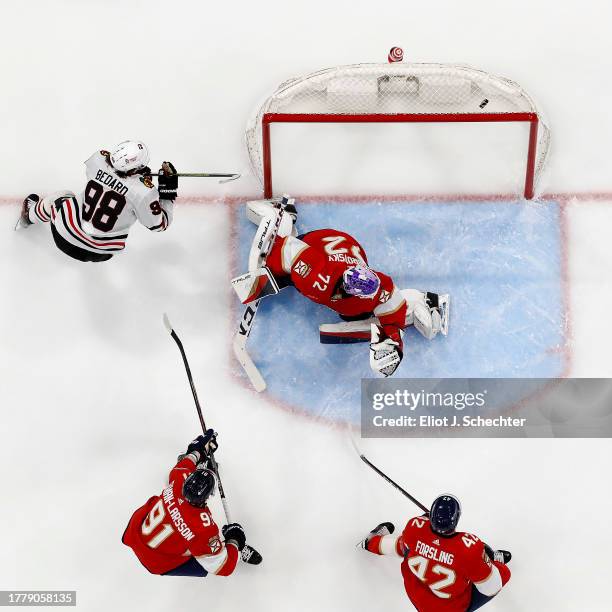 Connor Bedard of the Chicago Blackhawks scores against Goaltender Sergei Bobrovsky of the Florida Panthers at the Amerant Bank Arena on November 12,...