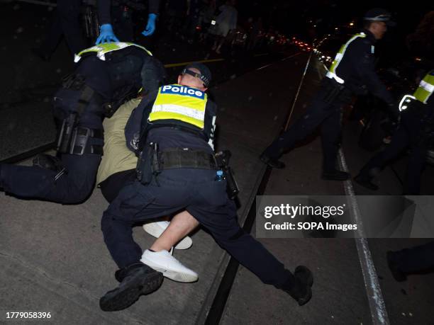 Police tackle a pro-Palestine protester who ran through a police line at the counter-protest. After a Burgertory chain-restaurant owned by...