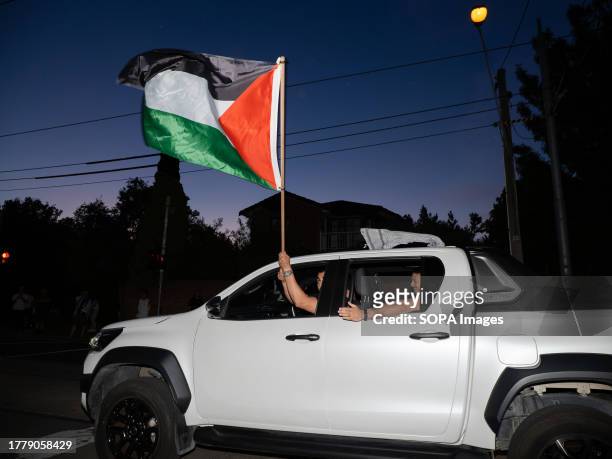 Palestinian flag is waved by a departing protester in front of the pro-Israel counter-protest After a Burgertory chain-restaurant owned by...