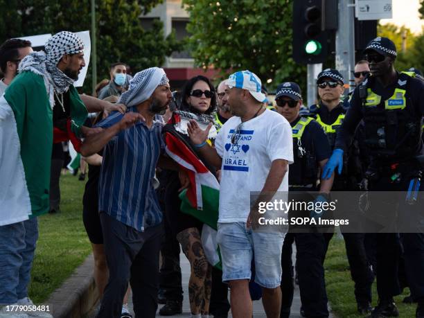 Tense exchanges happen as a pro-Israel protester walks past the pro-Palestine demonstration. After a Burgertory chain-restaurant owned by...