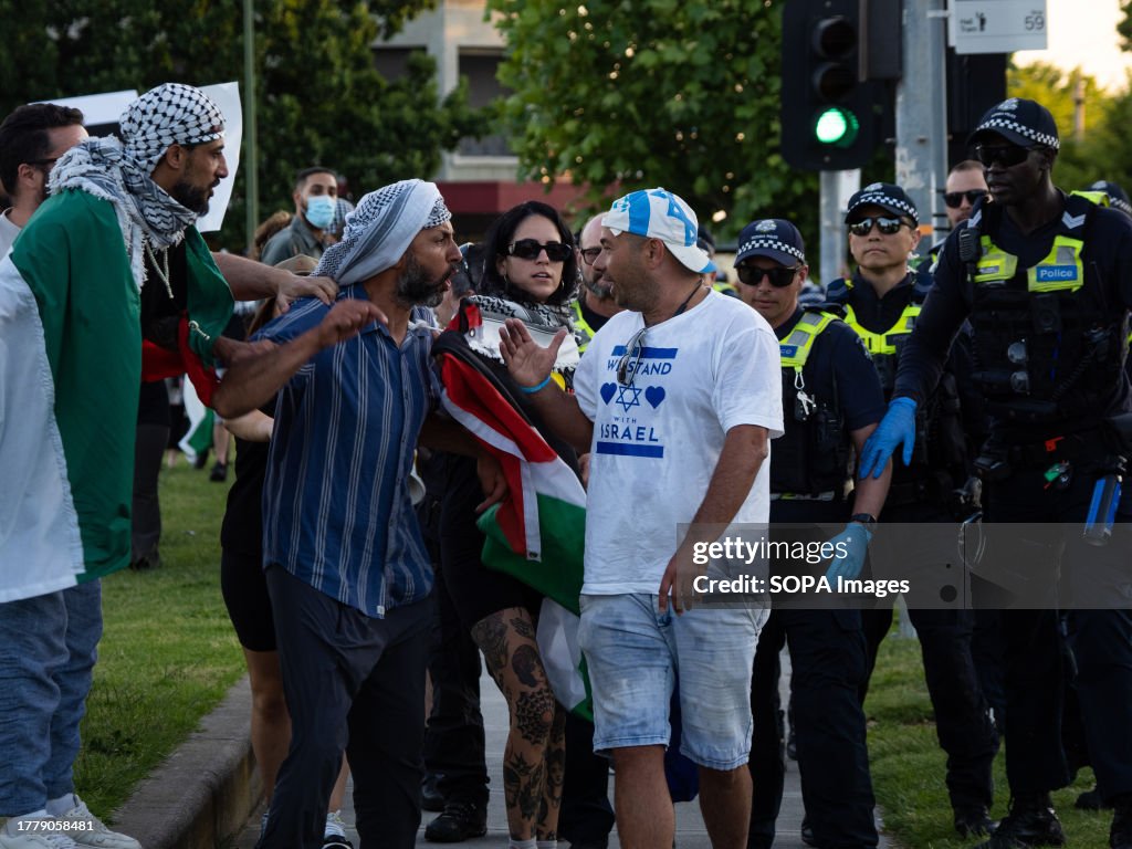 Tense exchanges happen as a pro-Israel protester walks past...