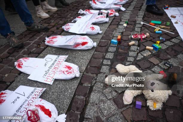 Bundles symbolizing dead children are seen during solidarity with Palestine demonstration at the Main Square in Krakow, Poland on November 12, 2023....