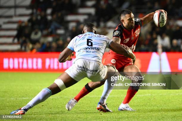 Toulon's Australian centre Duncan Paia'aua vies with Racing92's French lock Cameron Woki during the French Top14 rugby union match between Toulon and...