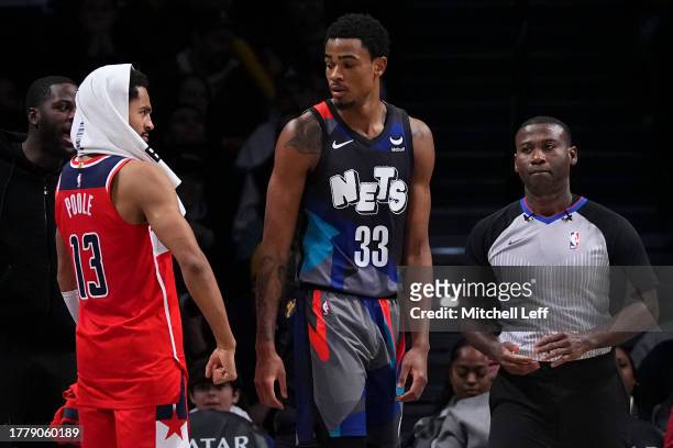 Jordan Poole of the Washington Wizards reacts in front of Nic Claxton of the Brooklyn Nets in the second half at Barclays Center on November 12, 2023...