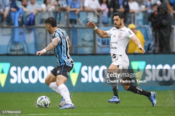 Carballo of Gremio and Giuliano of Corinthians compete for the ball during the match between Gremio and Corinthians as part of Brasileirao 2023 at...