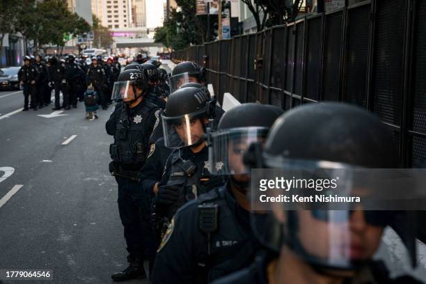 Police arrive to help escort vehicles blocked by protestors of the Asia-Pacific Economic Cooperation global trade summit headed for the Moscone...