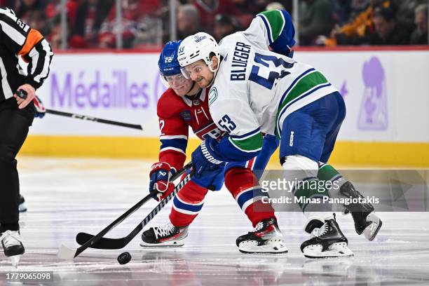Cole Caufield of the Montreal Canadiens and Teddy Blueger of the Vancouver Canucks battle for the puck during the second period at the Bell Centre on...