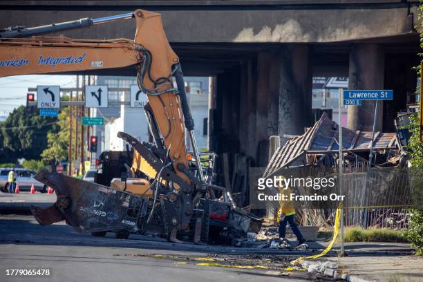 Los Angeles firefighters continue to assess the damage from a fire under Interstate 10 near downtown Los Angeles, CA November 12, 2023. A section of...