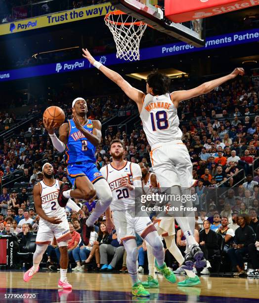 Shai Gilgeous-Alexander of the Oklahoma City Thunder drives to the basket during the game against the Phoenix Suns on November 12, 2023 at Footprint...