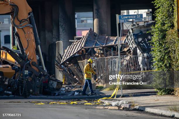 Los Angeles firefighters continue to assess the damage from a fire under Interstate 10 near downtown Los Angeles, CA November 12, 2023. A section of...