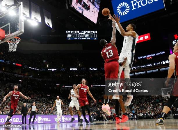Victor Wembanyama of the San Antonio Spurs shots over Bam Adebayo of the Miami Heat in the first half at Frost Bank Center on November 12, 2023 in...