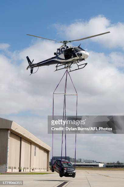 Helicopter is seen carrying a car during a Essendon Bombers Media Opportunity at the Melbourne Jet Base on November 13, 2023 in Melbourne, Australia.