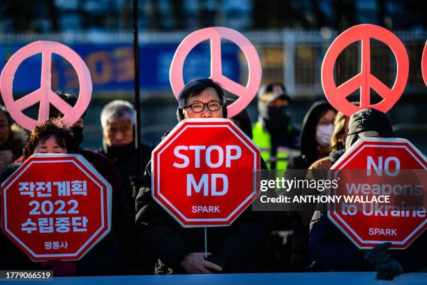 Activists protest in front of the presidential office in Seoul on November 13 as US Defense Secretary Lloyd Austin, who is in the city for annual...