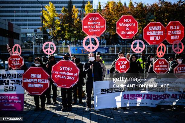 Activists protest in front of the presidential office in Seoul on November 13 as US Defense Secretary Lloyd Austin, who is in the city for annual...