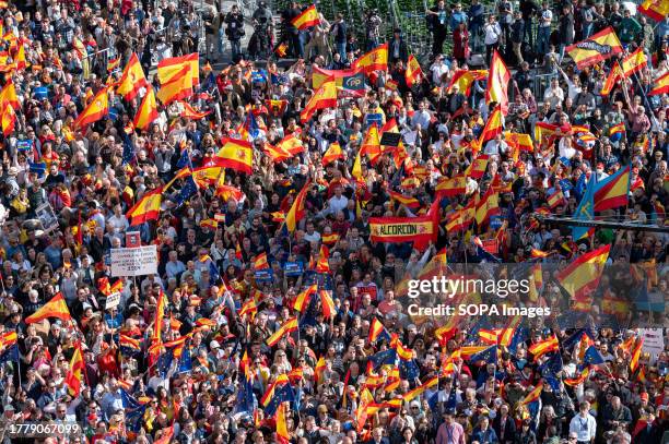 Protesters gather during a demonstration against the PSOE Socialist party's deal with Junts per Catalunya at Puerta del Sol. After the Prime Minister...