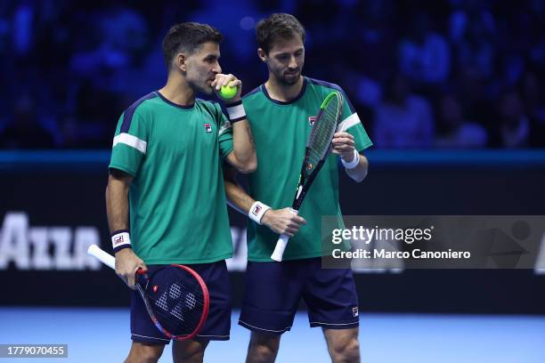 Andres Molteni of Argentina speaks with Maximo Gonzalez of Argentina during the Round Robin doubles match between Ivan Dodig of Croatia and Austin...