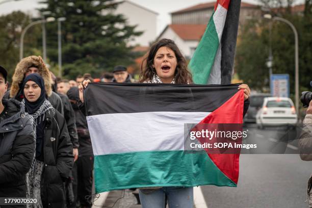 Woman is seen holding a Palestinian flag during the demonstration. Pro-Palestine demonstrators gathered at Construcciones y Auxiliar de Ferrocarriles...