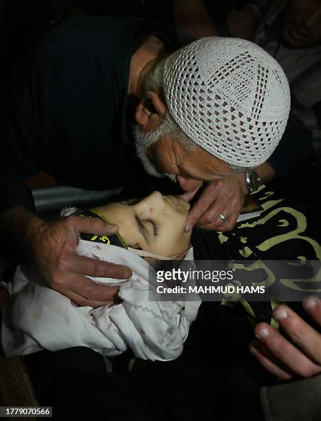 The Grandfather of youth Mohammed Ajuri one of five Palestinians killed in Beit Lahia earlier, kisses him farewell prior to his funeral procession in...