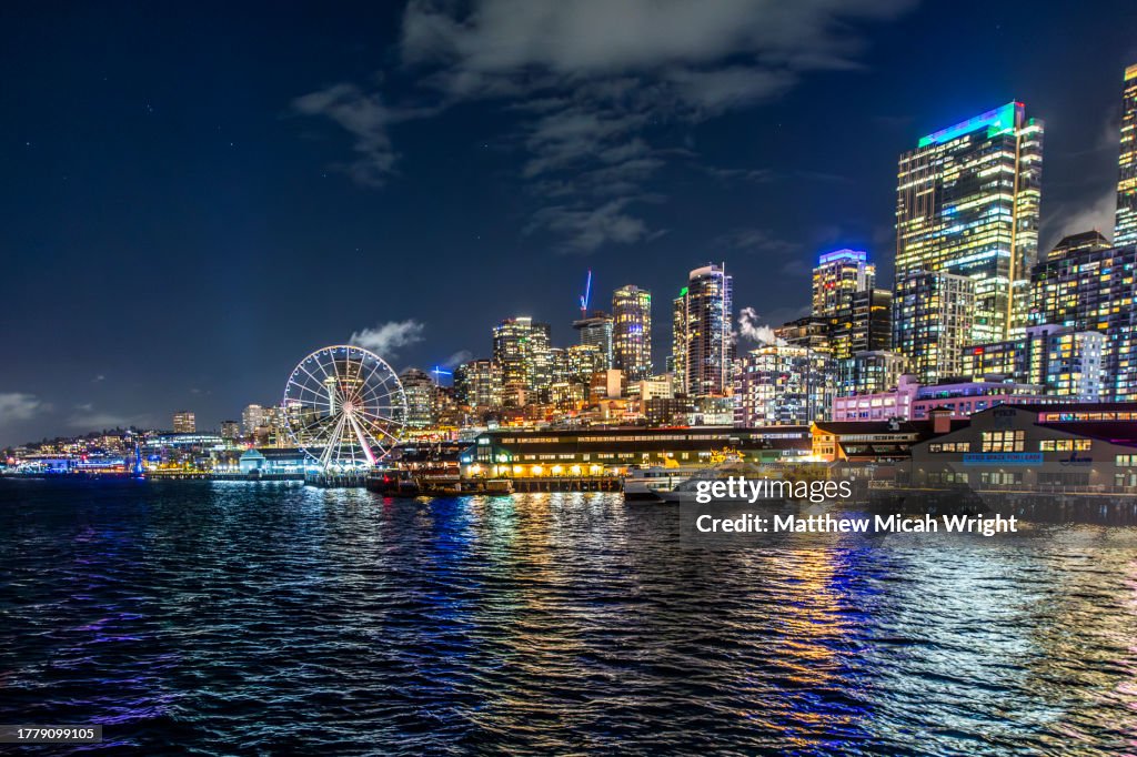 Views of downtown Seattle at night as seen from a boat.