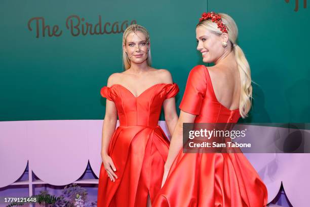 Eliza Spencer and Amelia Spencer pose for a photo during 2023 Melbourne Cup Day at Flemington Racecourse on November 07, 2023 in Melbourne, Australia.