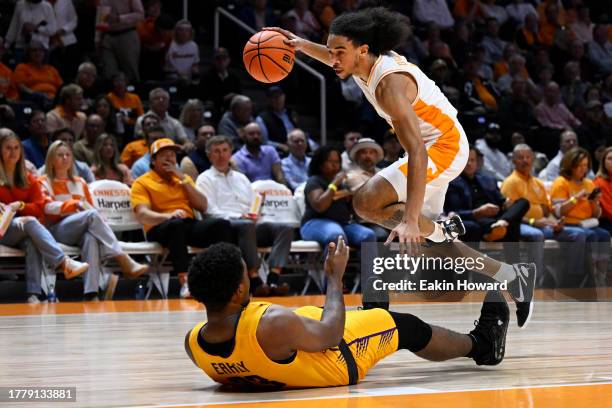 Freddie Dilione V of the Tennessee Volunteers is fouled by David Early of the Tennessee Tech Golden Eagles in the first half at Thompson-Boling Arena...