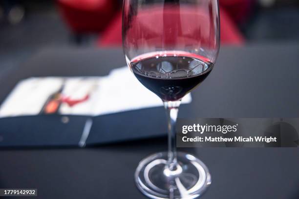 a glass of red wine at a wine tasting. - paso robles stockfoto's en -beelden