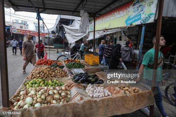 Palestinian people go shopping at the bazaar as they try to maintain their daily lives amid the Israeli attacks continue in Rafah, Gaza on November...