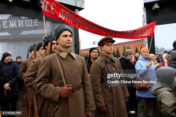 People wearing Soviet military uniforms march during an exhibition of Soviet tanks and military vehicles at Red Square on November 6, 2023 in Moscow,...