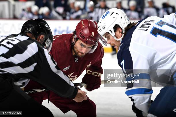 Nick Schmaltz of the Arizona Coyotes gets ready to take a face off against Adam Lowry of the Winnipeg Jets at Mullett Arena on November 04, 2023 in...