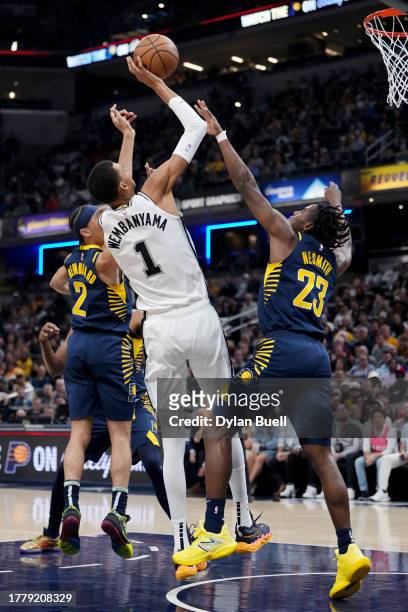 Victor Wembanyama of the San Antonio Spurs attempts a shot while being guarded by Aaron Nesmith of the Indiana Pacers in the second quarter at...