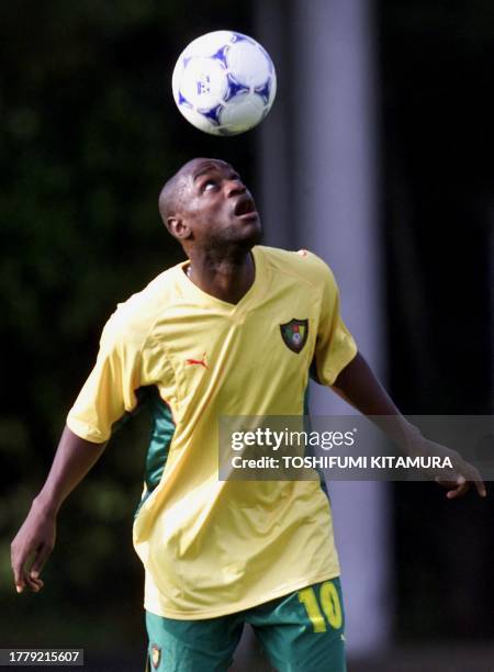 Cameroon's Patrick Mboma juggles the ball during a training session in Kashima, 100 km north of Tokyo, 29 May 2001. Cameron will face Brazil in their...