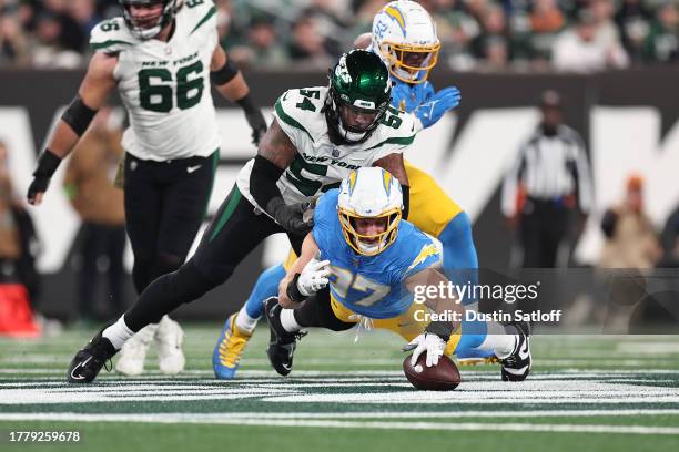 Joey Bosa of the Los Angeles Chargers recovers a fumble during the first quarter against the New York Jets at MetLife Stadium on November 06, 2023 in...