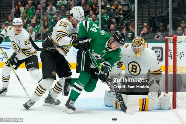 Roope Hintz of the Dallas Stars is pushed by Brandon Carlo of the Boston Bruins in front of the net during the first period at American Airlines...