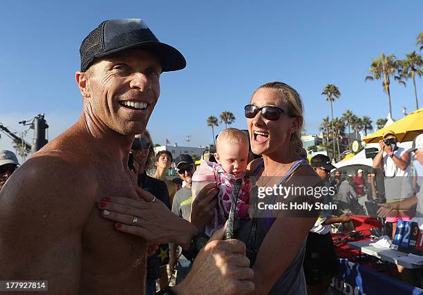 Casey Jennings is greeted by his wife Kerri Walsh Jennings and their daughter Scout after he won the men's finals at the AVP Manhattan Beach Open....