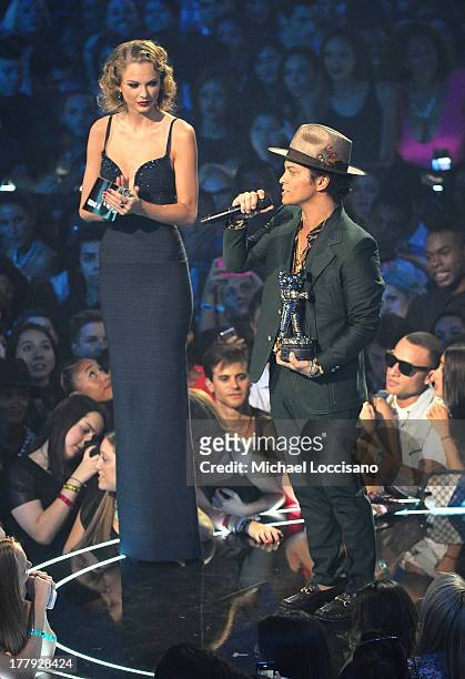Taylor Swift and Bruno Mars speak onstage during the 2013 MTV Video Music Awards at the Barclays Center on August 25, 2013 in the Brooklyn borough of...