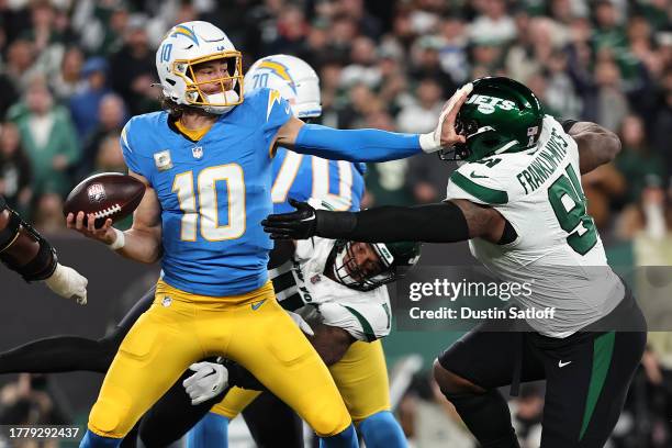 John Franklin-Myers of the New York Jets sacks Justin Herbert of the Los Angeles Chargers during the second quarter at MetLife Stadium on November...