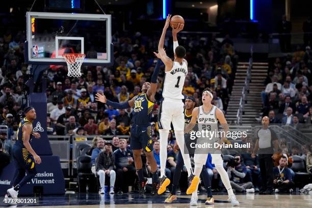 Victor Wembanyama of the San Antonio Spurs attempts a shot while being guarded by Bennedict Mathurin of the Indiana Pacers in the third quarter at...