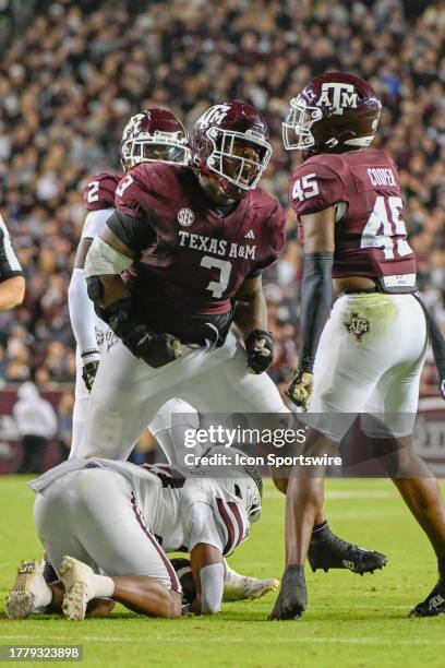 Texas A&M Aggies defensive lineman McKinnley Jackson and Texas A&M Aggies linebacker Edgerrin Cooper celebrate a big stop on Mississippi State...