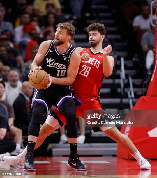 Domantas Sabonis of the Sacramento Kings drives against Alperen Sengun of the Houston Rockets during the second half at Toyota Center on November 06,...