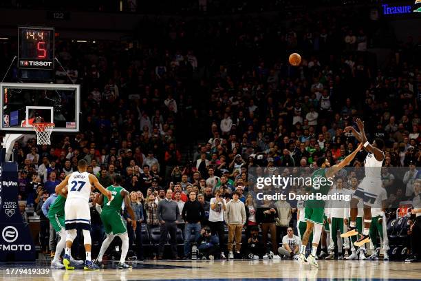 Anthony Edwards of the Minnesota Timberwolves shoots the ball while Jayson Tatum of the Boston Celtics defends in the fourth quarter at Target Center...