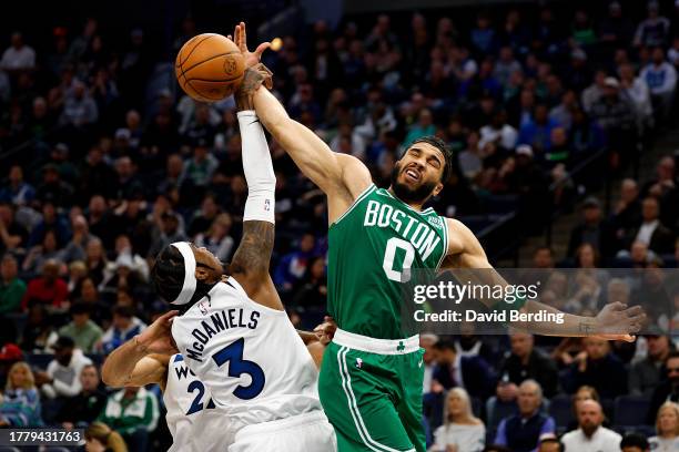 Jayson Tatum of the Boston Celtics and Jaden McDaniels of the Minnesota Timberwolves compete for the rebound in the third quarter at Target Center on...