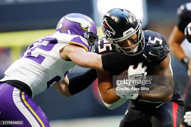 Tyler Allgeier of the Atlanta Falcons runs the ball against Harrison Smith of the Minnesota Vikings during the fourth quarter at Mercedes-Benz...