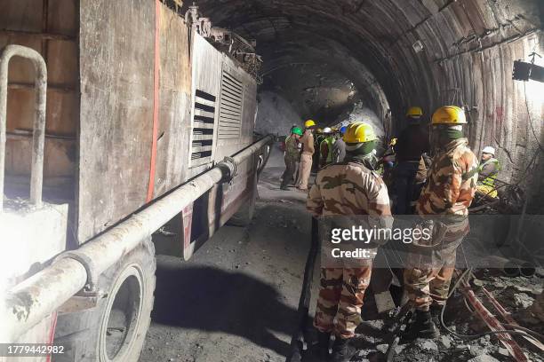 Rescue workers gather at the site after a tunnel collapsed in the Uttarkashi district of India's Uttarakhand state on November 13, 2023. Rescue...