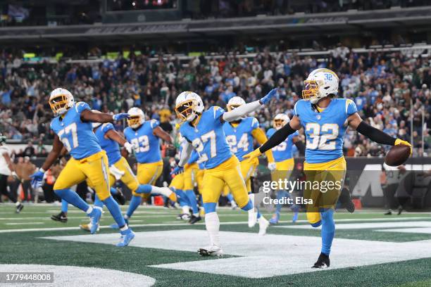 Alohi Gilman of the Los Angeles Chargers celebrates with teammates after recovering a fumble during the fourth quarter against the New York Jets at...